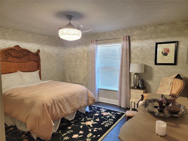 bedroom with baseboards and wood finished floors
