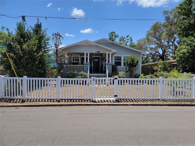 view of front of house with a fenced front yard and covered porch