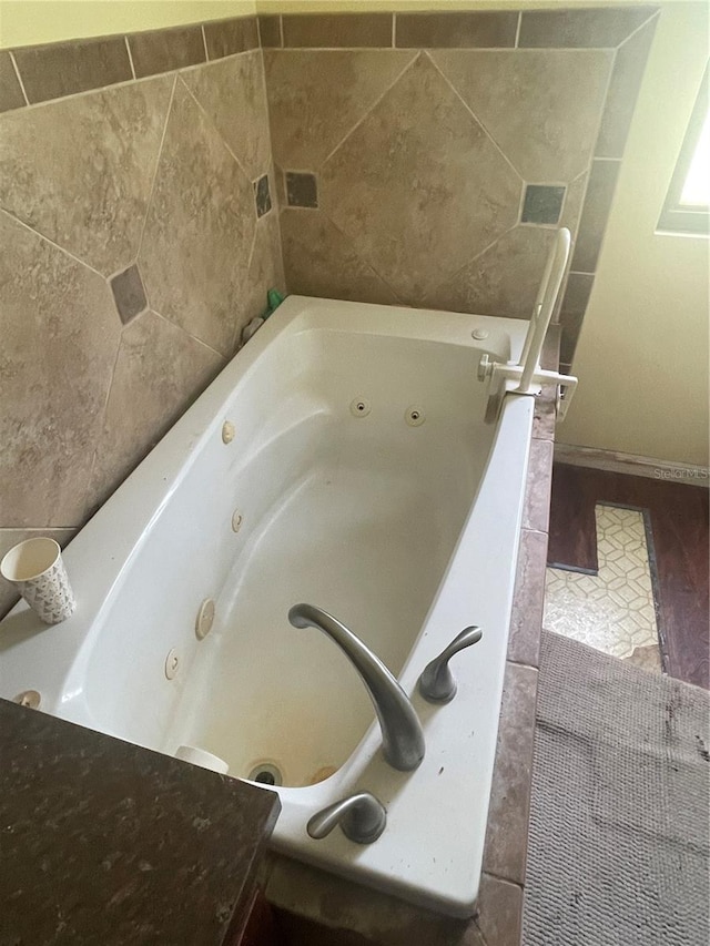 bathroom featuring a tub with jets