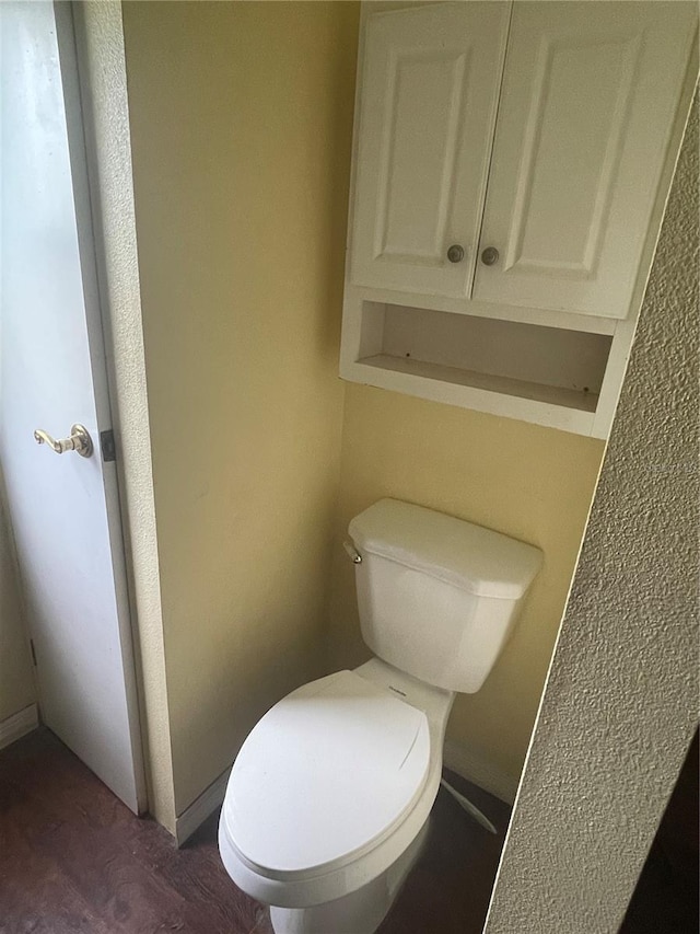 bathroom featuring toilet and wood finished floors