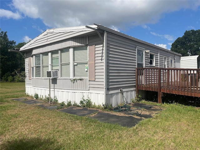 view of property exterior with a wooden deck and a yard