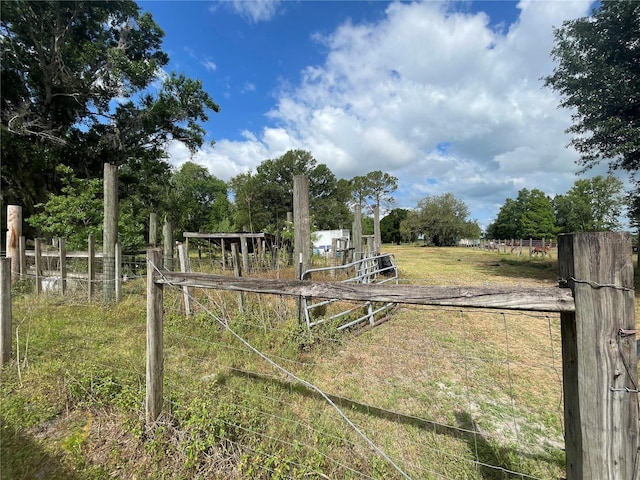 view of yard featuring a rural view and fence