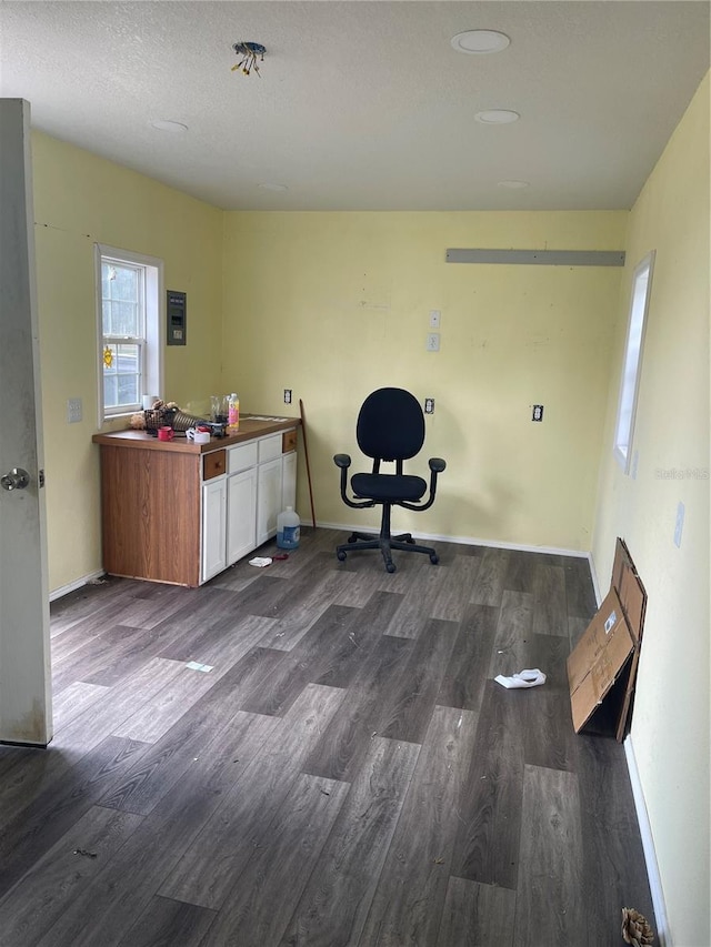 office featuring dark wood-type flooring, a textured ceiling, and baseboards