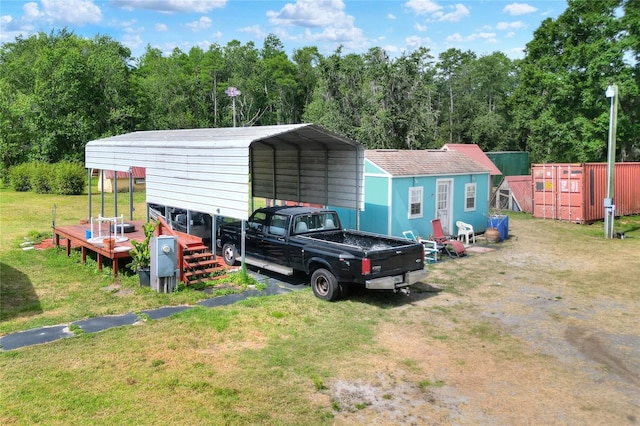 view of outdoor structure with a carport and driveway