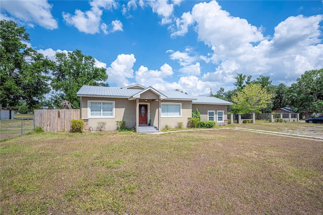 view of front of house featuring stucco siding and metal roof