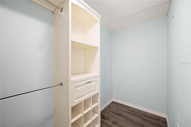 spacious closet featuring dark wood-type flooring and attic access