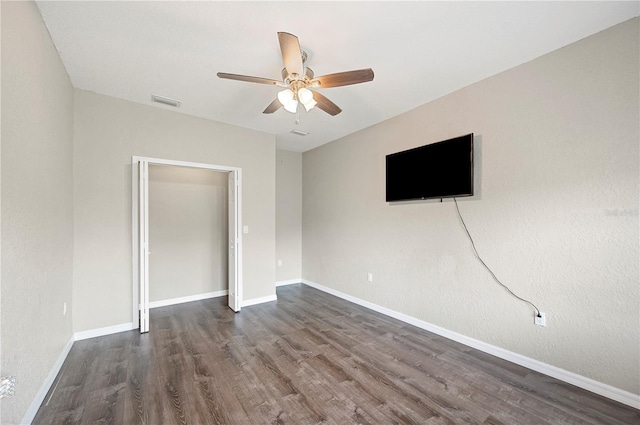 unfurnished living room featuring a ceiling fan, wood finished floors, and baseboards
