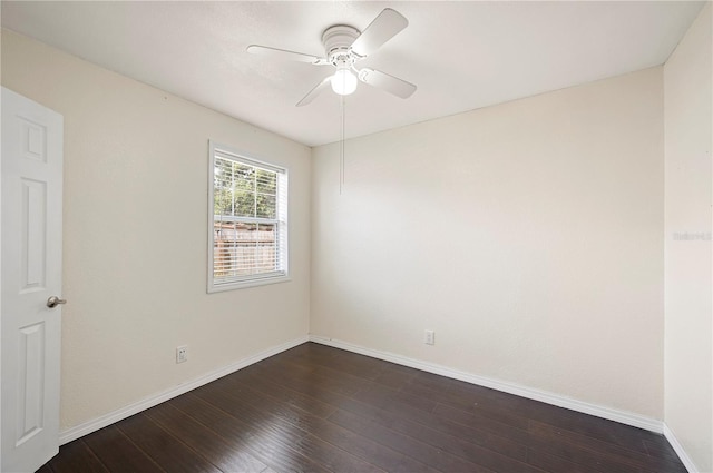 empty room featuring dark wood-style flooring, baseboards, and a ceiling fan