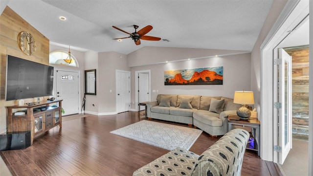 living room featuring baseboards, ceiling fan, vaulted ceiling, and wood finished floors