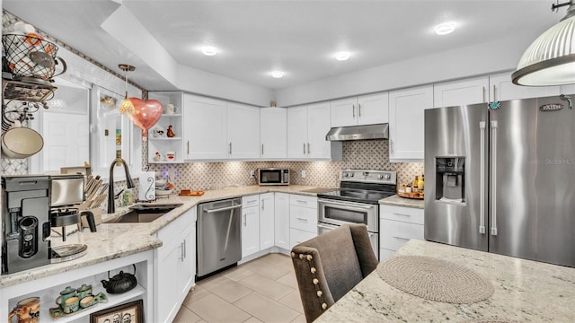 kitchen with decorative backsplash, open shelves, a sink, under cabinet range hood, and stainless steel appliances