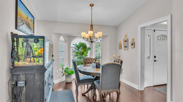 dining room featuring baseboards, a chandelier, and dark wood-type flooring