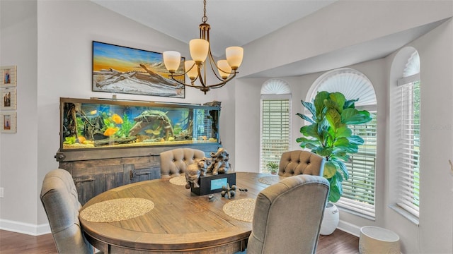 dining area with baseboards, vaulted ceiling, wood finished floors, and a notable chandelier