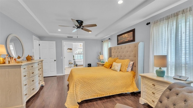 bedroom featuring recessed lighting, baseboards, a ceiling fan, a tray ceiling, and dark wood-style floors