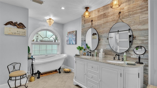 full bathroom with baseboards, a sink, double vanity, and a soaking tub