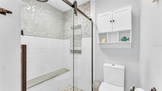 full bathroom featuring toilet and a shower stall
