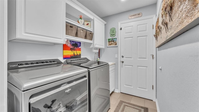 laundry area featuring cabinet space, independent washer and dryer, and light tile patterned floors