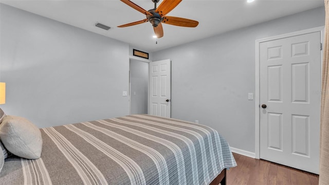 bedroom with ceiling fan, recessed lighting, baseboards, wood finished floors, and visible vents
