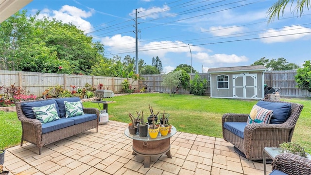 view of patio featuring a fenced backyard, an outbuilding, a shed, and outdoor lounge area
