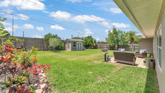 view of yard featuring a storage shed, a fenced backyard, an outdoor living space, a patio area, and an outdoor structure