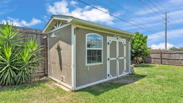 view of shed with a fenced backyard