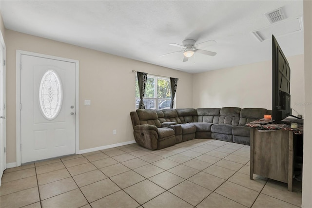 living area with baseboards, ceiling fan, visible vents, and light tile patterned floors