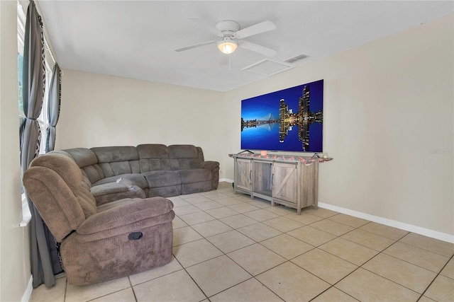living area featuring ceiling fan, attic access, visible vents, baseboards, and light tile patterned flooring