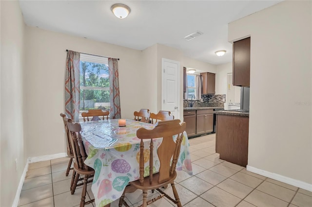 dining area featuring visible vents, baseboards, and light tile patterned floors
