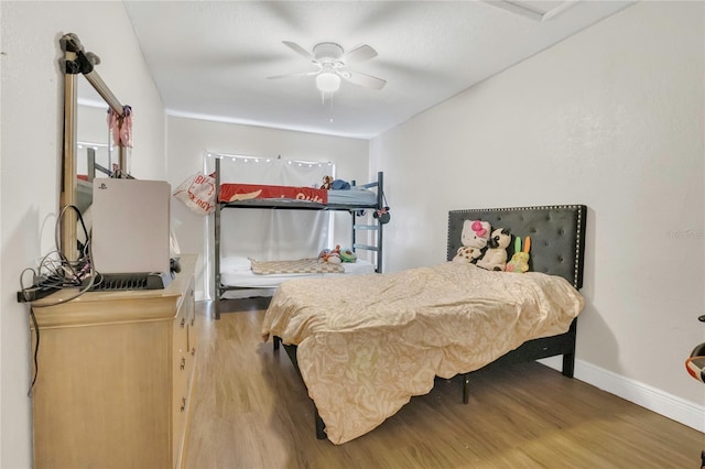 bedroom featuring baseboards, ceiling fan, and wood finished floors