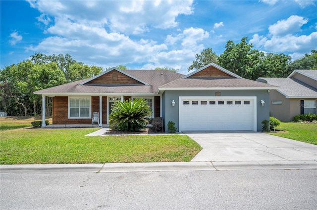 view of front facade with an attached garage, stucco siding, a shingled roof, a front yard, and driveway
