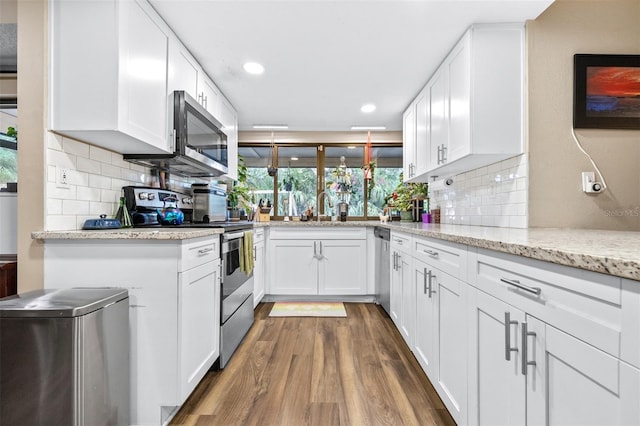 kitchen featuring appliances with stainless steel finishes, white cabinetry, and dark wood-type flooring