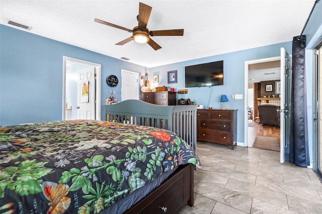 bedroom featuring visible vents, a textured ceiling, connected bathroom, and ceiling fan