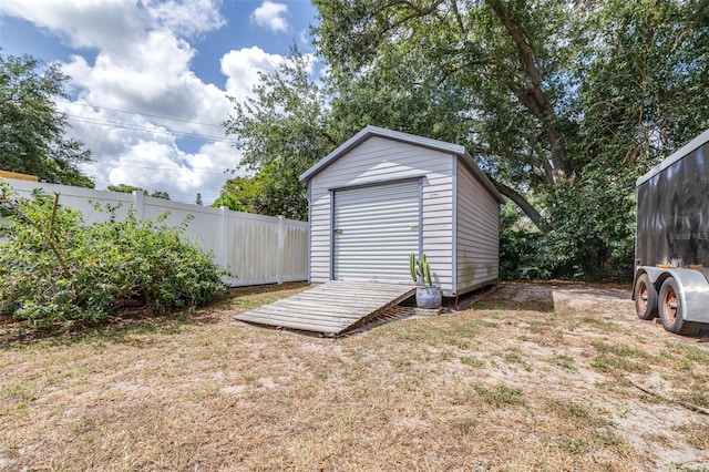 view of shed featuring fence