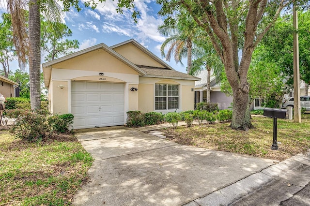 2660 Hemingway Ave, Haines City, FL 33844 - ranch-style home with an attached garage, stucco siding, and driveway