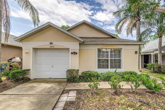 2660 Hemingway Ave, Haines City, FL 33844 - single story home featuring concrete driveway, stucco siding, and a garage