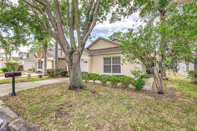 2660 Hemingway Ave, Haines City, FL 33844 - view of front of house with concrete driveway and stucco siding