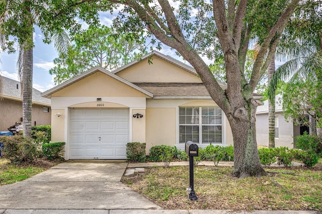 2660 Hemingway Ave, Haines City, FL 33844 - single story home featuring driveway, stucco siding, a shingled roof, and an attached garage