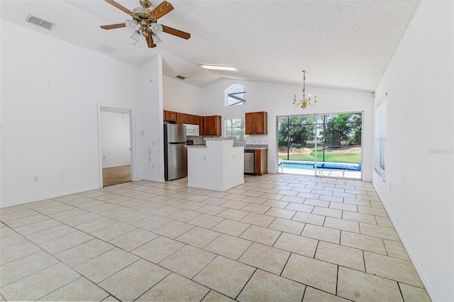 2660 Hemingway Ave, Haines City, FL 33844 - kitchen with vaulted ceiling, visible vents, open floor plan, a kitchen island, and appliances with stainless steel finishes