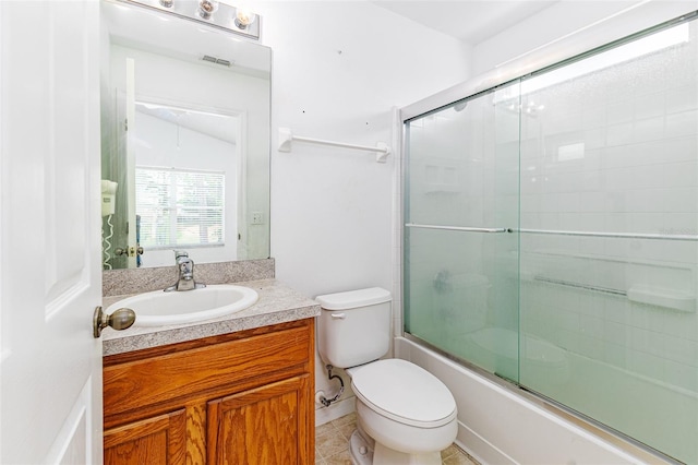 2660 Hemingway Ave, Haines City, FL 33844 - bathroom featuring toilet, vanity, visible vents, tile patterned floors, and combined bath / shower with glass door