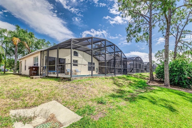 2660 Hemingway Ave, Haines City, FL 33844 - back of property featuring an outdoor pool, glass enclosure, and a lawn