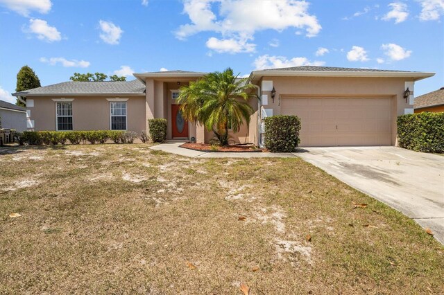 2812 Hickory Ridge Dr, Lakeland, FL 33813 - view of front facade featuring concrete driveway, a garage, a front lawn, and stucco siding