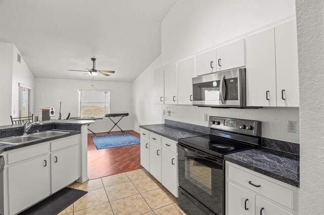 2812 Hickory Ridge Dr, Lakeland, FL 33813 - kitchen with visible vents, a sink, dark countertops, a ceiling fan, and appliances with stainless steel finishes