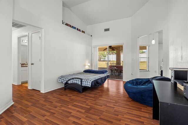 2812 Hickory Ridge Dr, Lakeland, FL 33813 - bedroom featuring visible vents, wood finished floors, high vaulted ceiling, and access to exterior