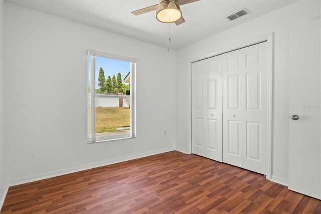 2812 Hickory Ridge Dr, Lakeland, FL 33813 - unfurnished bedroom with baseboards, a closet, wood finished floors, and visible vents