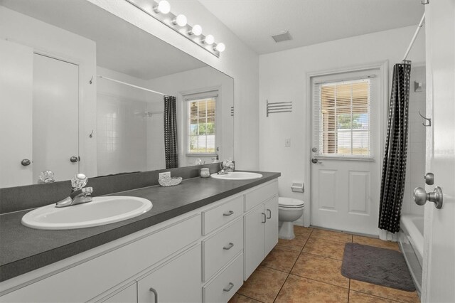 2812 Hickory Ridge Dr, Lakeland, FL 33813 - full bathroom with a sink, tile patterned floors, toilet, and double vanity