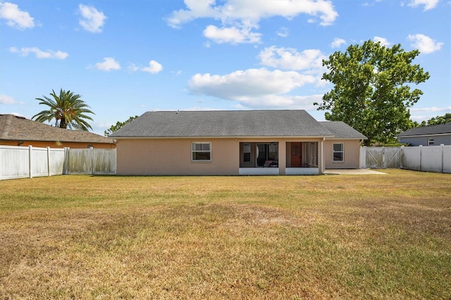 2812 Hickory Ridge Dr, Lakeland, FL 33813 - rear view of property with a fenced backyard, stucco siding, and a yard