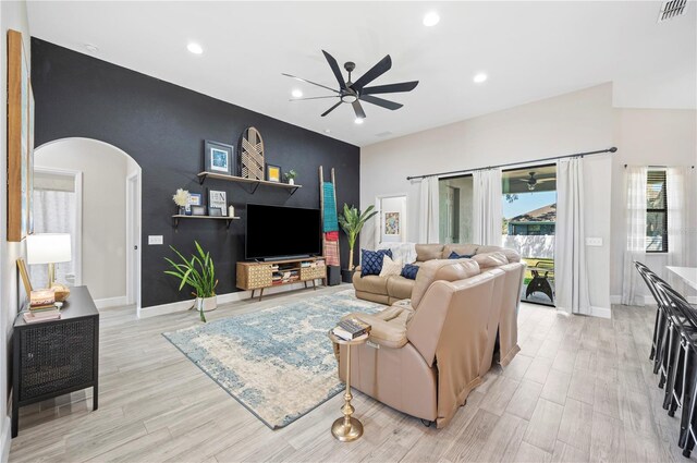 5531 Pebble Beach Dr, Lakeland, FL 33812 - living room featuring arched walkways, an accent wall, a ceiling fan, recessed lighting, and visible vents