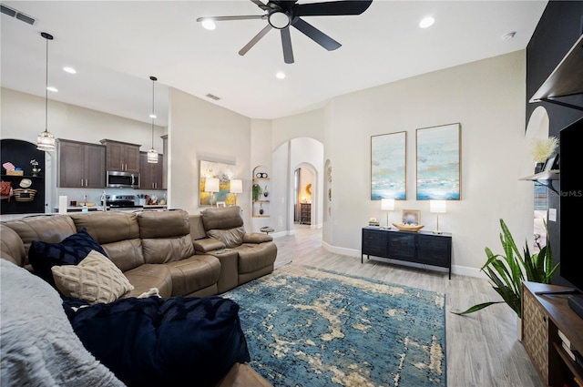 5531 Pebble Beach Dr, Lakeland, FL 33812 - living area featuring ceiling fan, light wood-style floors, arched walkways, recessed lighting, and visible vents