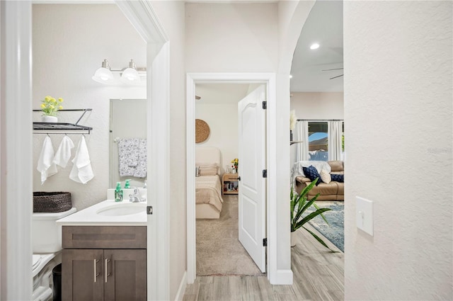 5531 Pebble Beach Dr, Lakeland, FL 33812 - bathroom featuring vanity, a textured wall, wood finished floors, toilet, and ensuite bathroom