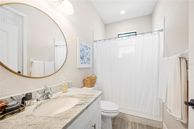 5531 Pebble Beach Dr, Lakeland, FL 33812 - full bathroom featuring vanity, a shower with curtain, toilet, and wood finished floors