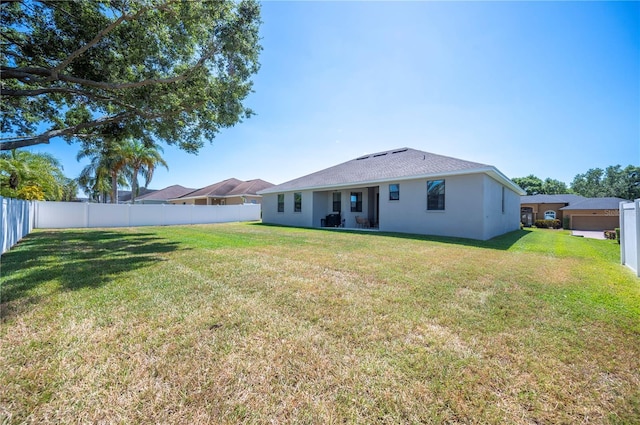 5531 Pebble Beach Dr, Lakeland, FL 33812 - rear view of property with a yard, a fenced backyard, and stucco siding
